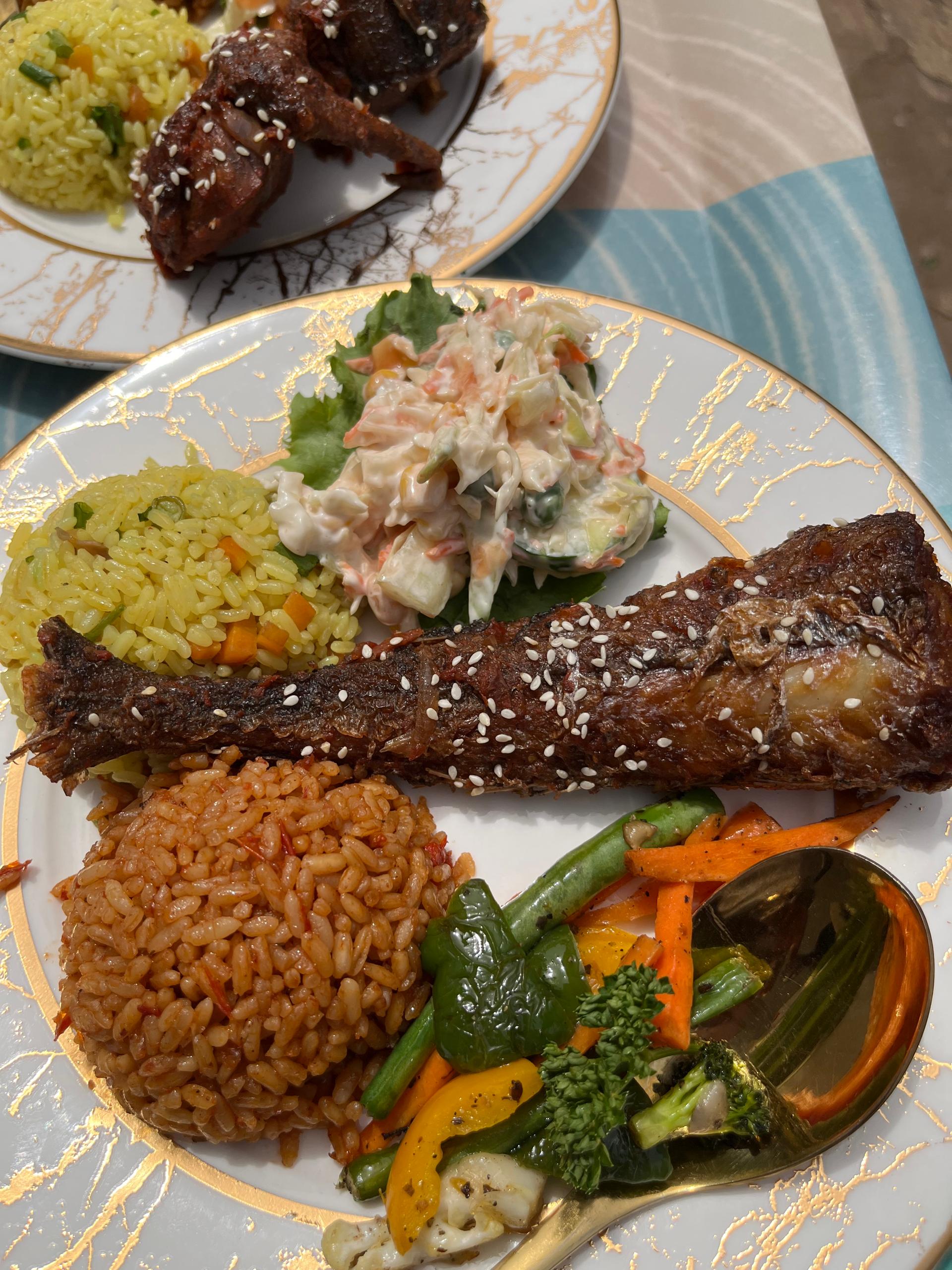 Smokey Jollof Rice, Fried Rice, Creamy Salad, Special Vegies with Peppered Hake Fish